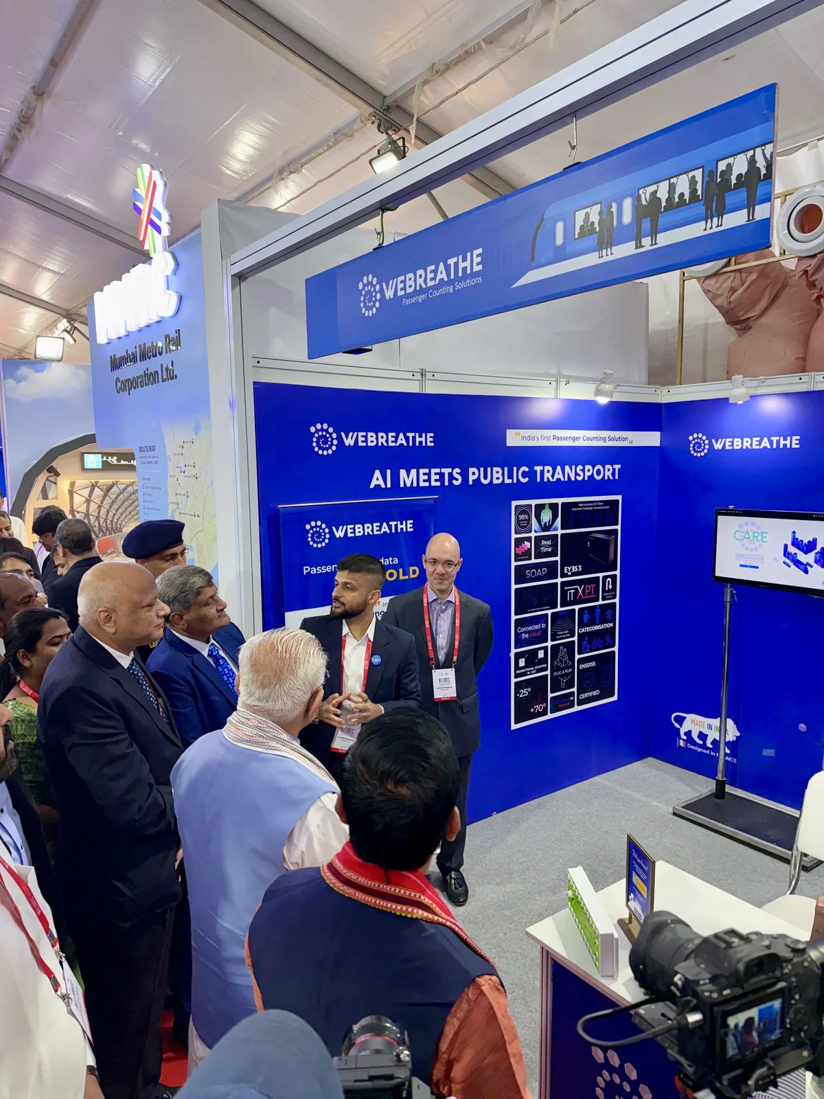 Attendees and camera crews gathered for a WEBREATHE booth presentation